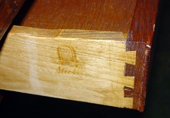 Close-up, branded signature on drawer side.  Circa 1912-1916.